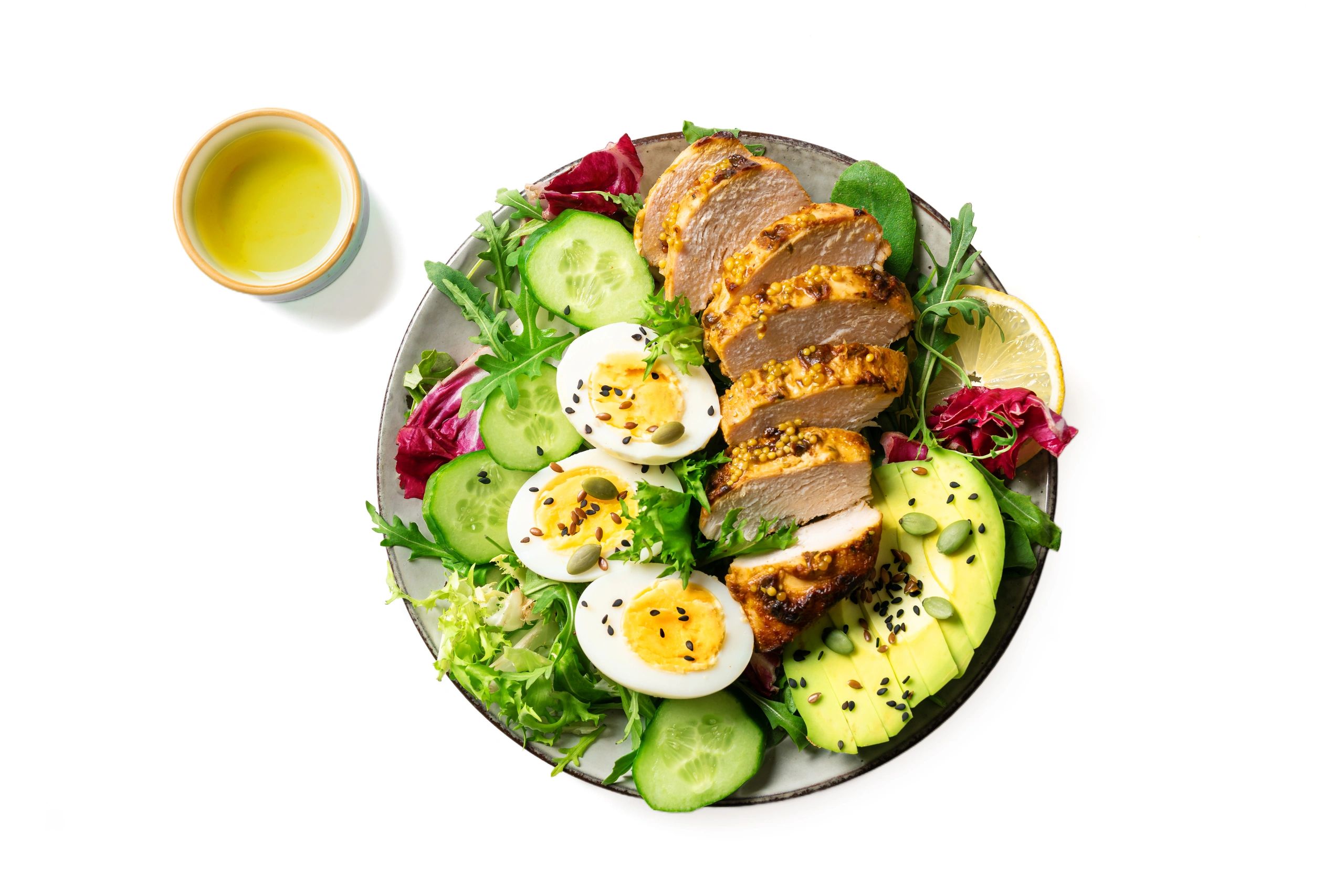 High protein lunch bowl with chicken, eggs and vegetables