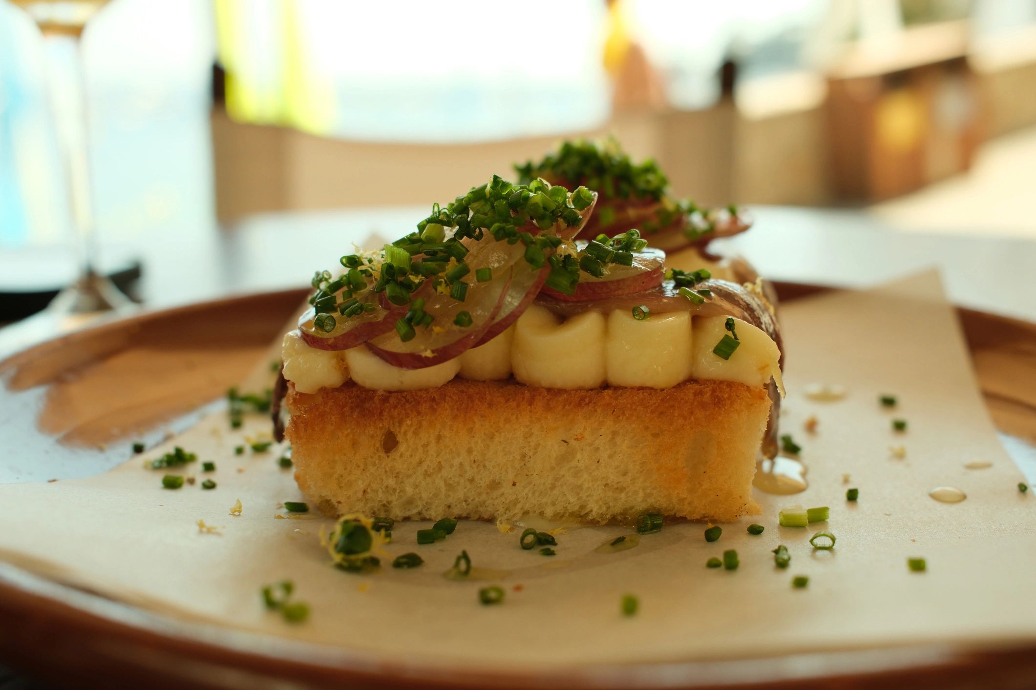 Prepared gourmet toast and ingredients on a dining surface