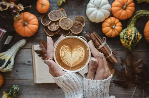 Pumpkin spice coffee in a cozy autumn setting