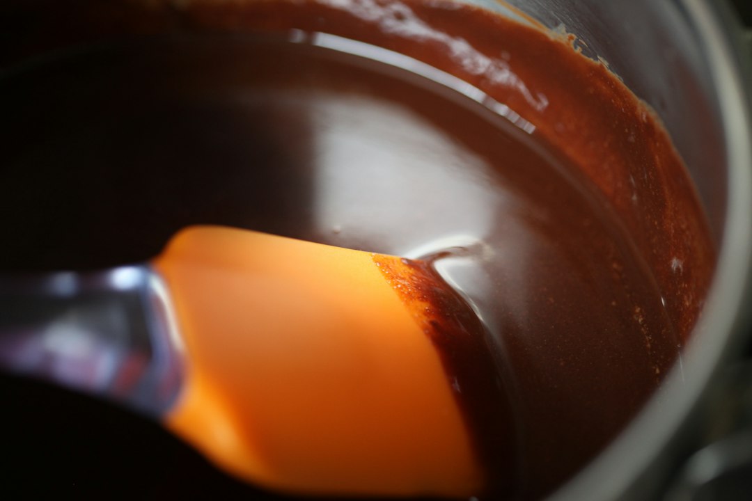 Sauce mixture simmering in a pan during homemade syrup preparation
