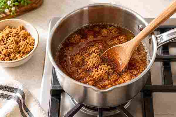 Brown Sugar Syrup for Coffee: Easy Homemade Recipe 3 Brown sugar dissolving in a saucepan for homemade brown sugar syrup for coffee