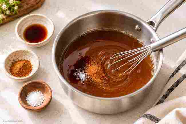 Brown Sugar Syrup for Coffee: Easy Homemade Recipe 5 Vanilla, cinnamon, and salt being whisked into brown sugar syrup for coffee
