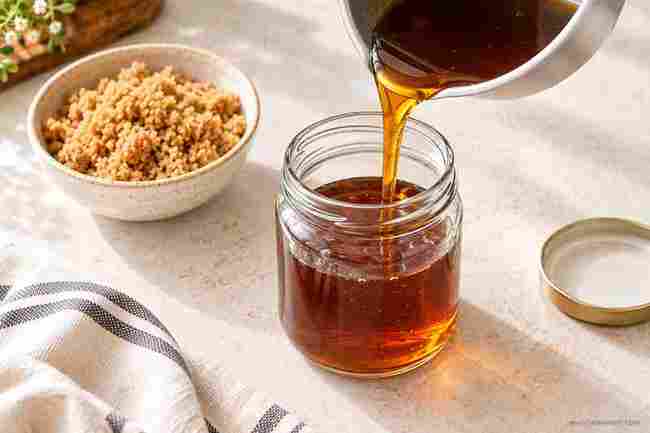 Brown Sugar Syrup for Coffee: Easy Homemade Recipe 6 Homemade brown sugar syrup for coffee being poured into a glass jar