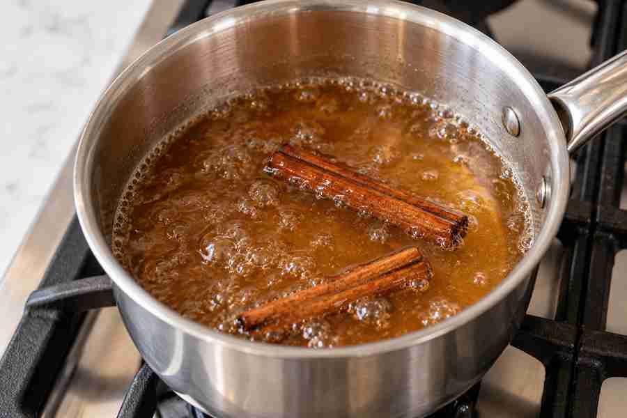 Cinnamon Dolce Syrup: Easy Homemade Coffee Syrup 4 Cinnamon dolce syrup simmering with cinnamon sticks in a saucepan