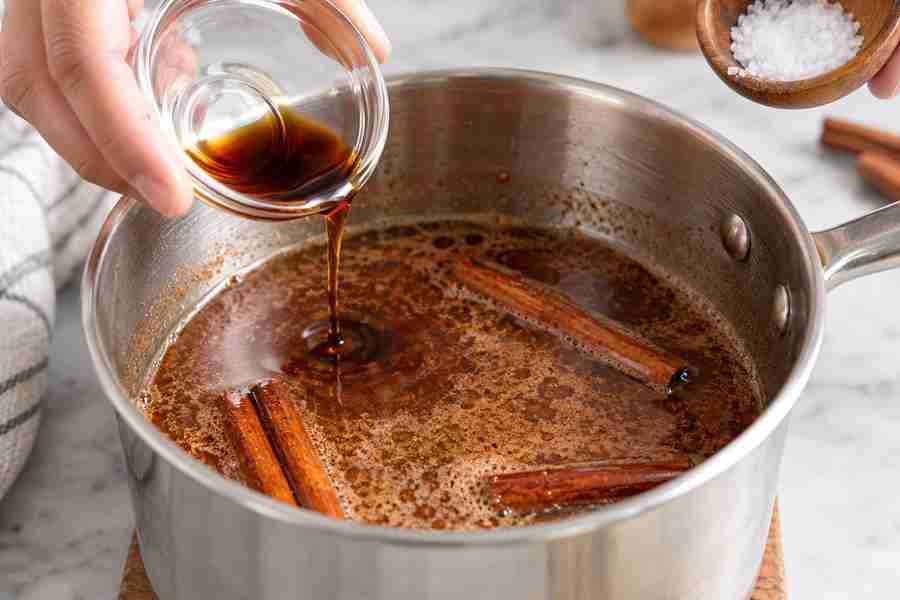 Cinnamon Dolce Syrup: Easy Homemade Coffee Syrup 5 Vanilla and salt being stirred into cinnamon dolce syrup after simmering