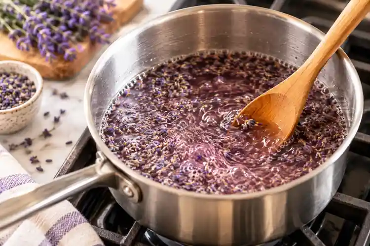 Lavender Syrup for Coffee: Easy Homemade Recipe 3 Homemade lavender simple syrup gently simmering on the stove