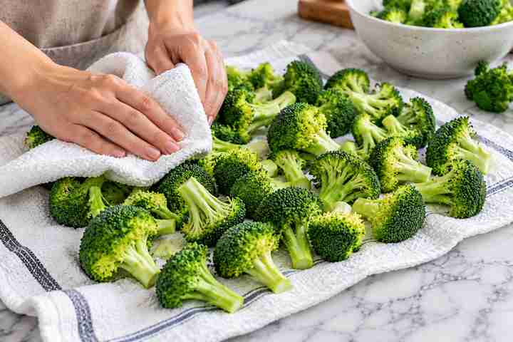 Breaded Broccoli Air Fryer Recipe (Golden & Crispy) 3 Fresh broccoli florets being thoroughly dried before breading - Breaded Broccoli Air Fryer