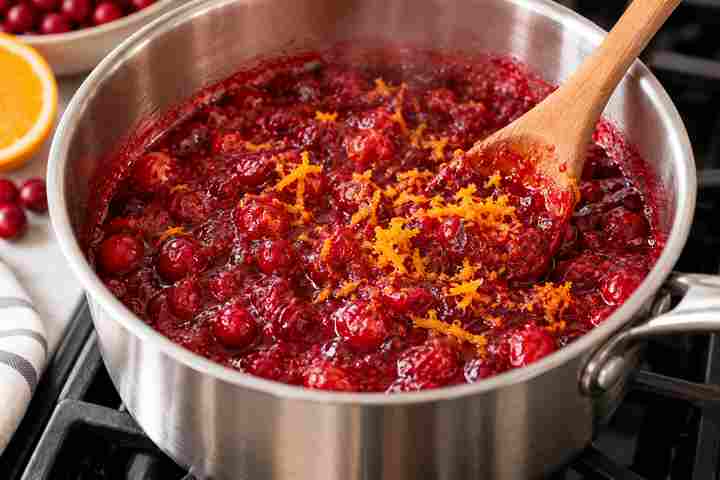 Homemade Cranberry Sauce Recipe With Orange 6 Fresh orange zest being stirred into thick homemade cranberry sauce after cooking
